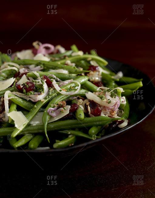 Stewed green bean with onion on a wooden table