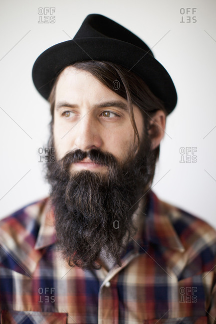 Profile of male character wearing long beard, hat and lumberjack shirt