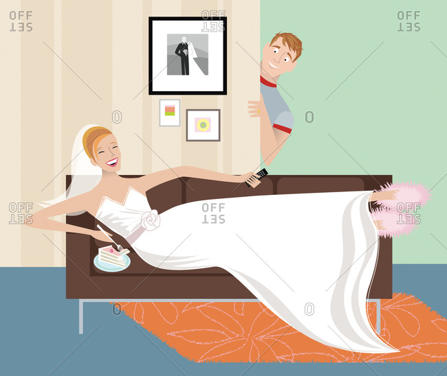 Bride in wedding dress and slippers laying on a sofa and eating cake