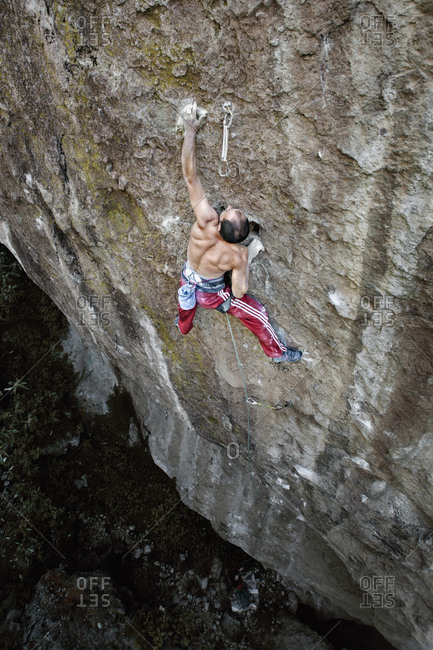 A man without shirt and red pants rock climbing in Jilotepec, Estado de Mexico, Mexico