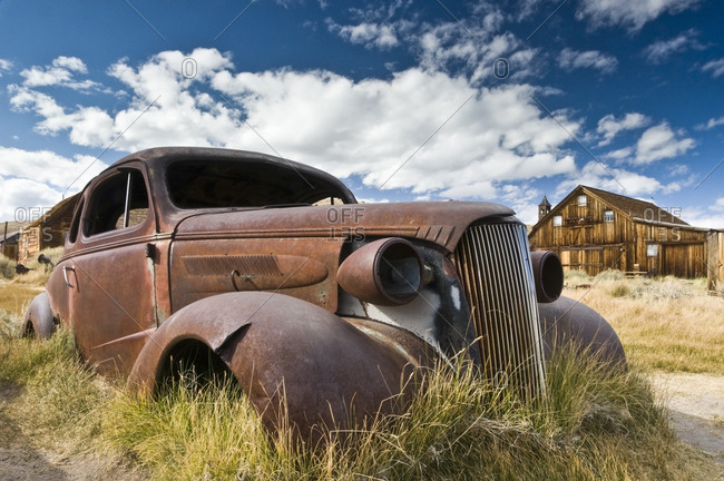 An old abandoned car rusts away in the ghost town of Bodie, CA