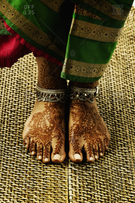 Feet with tattoos and anklets
