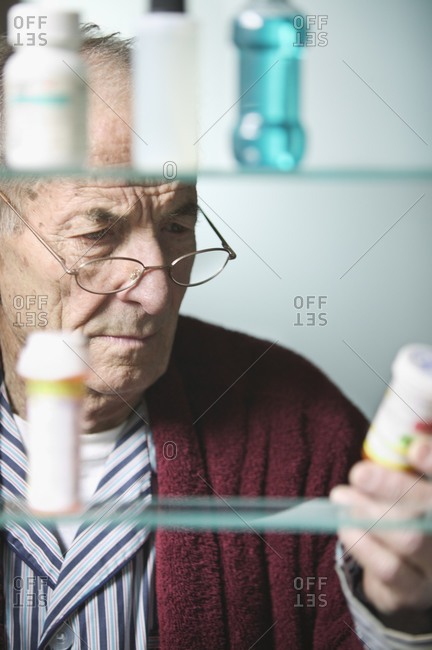 Senior man reading medicine label
