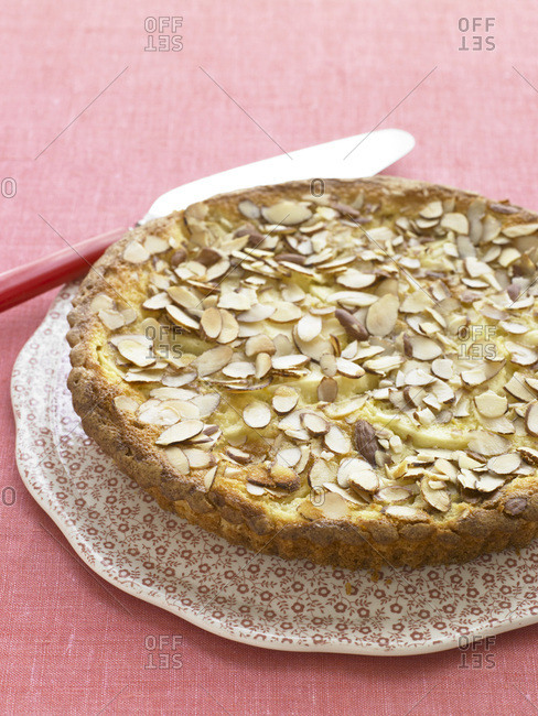 Apple tart with almond flakes on top.