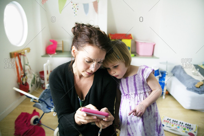 Mother with daughter looking at cell phone