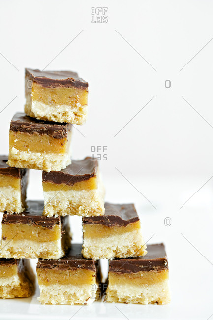 Caramel bars with melted chocolate in stack