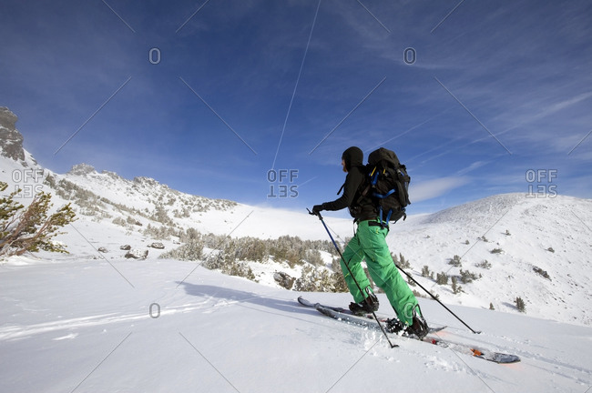 A snowboarder on a splitboard skins up Red Lake Peak near Lake Tahoe, CA.