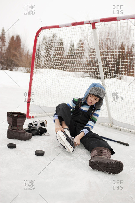 Boy Putting On Hockey Skates, Frisco, Summit County, Colorado, USA