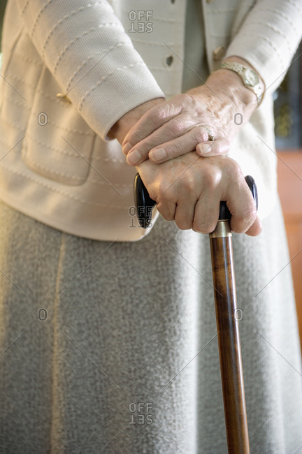 Older woman walking with cane