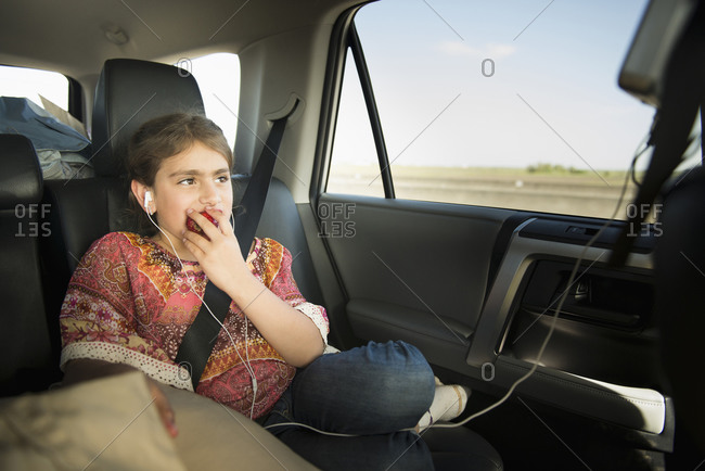 Girl eating apple in car