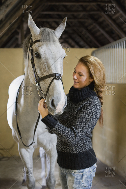 Happy woman with white horse