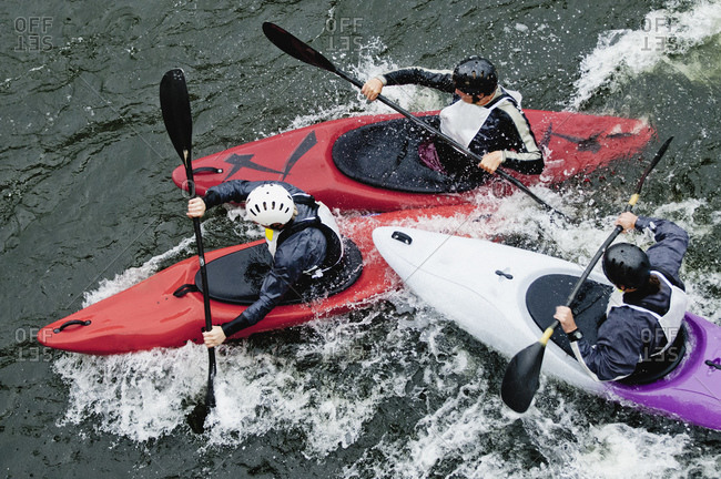 High angle view of people kayaking in rapid water