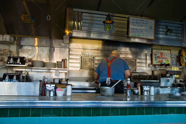 Cook behind the counter of a diner