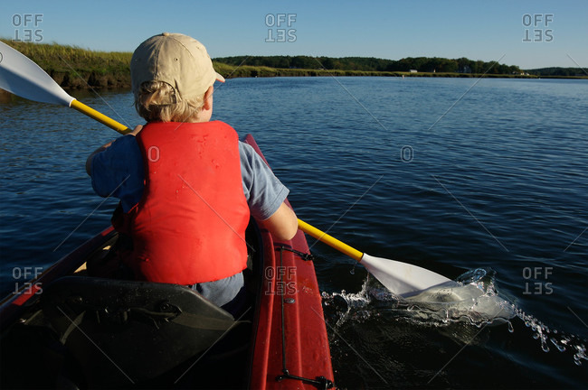 An elementary age boy ocean kayaking