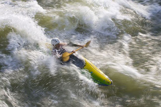 A man Kayaking in the white water of the Potomac River