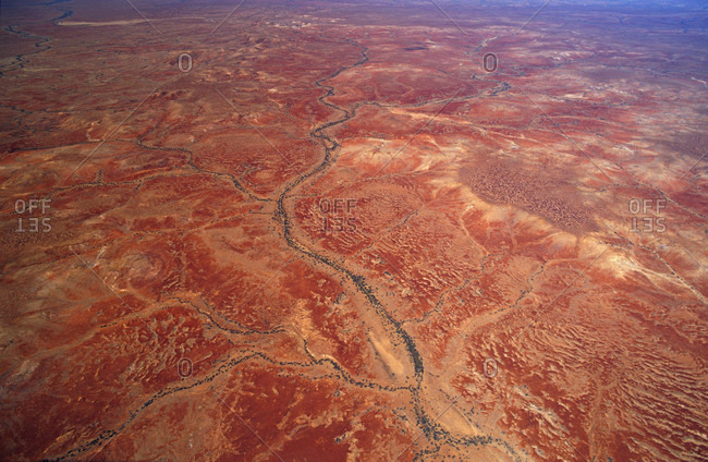 A vast red desert plain scoured by ancient dry river beds