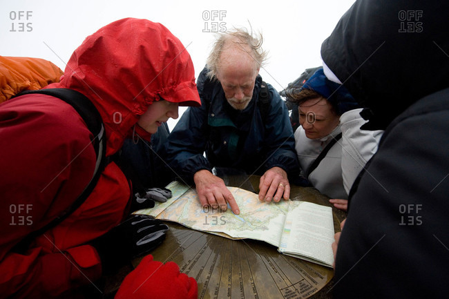 Tourists looking at map on Mount Snowdon in Wales, England