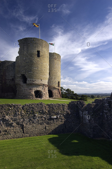 Flags wave atop the towers of medieval Rhuddlan Castle