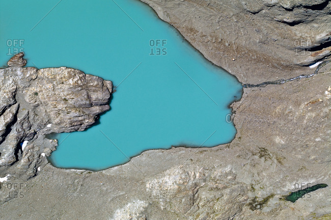 A lake fills with mineral-rich turquoise water from a glacier run-off.