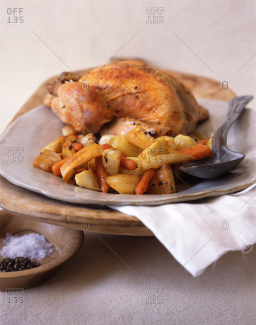 Roasted chicken with vegetables: squash, carrots and onions