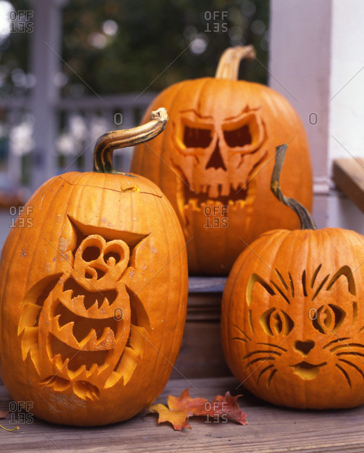 Three various designs of carving a Halloween pumpkin