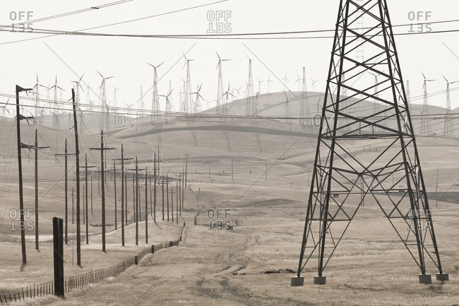Wind turbines, utility poles, and high-tension powerlines