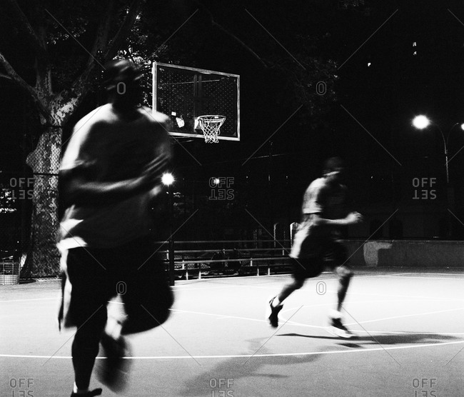 Men Playing Basketball At Night