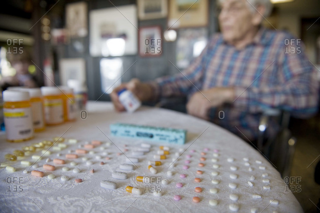 A man counts out one week\'s worth of pills