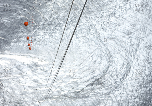 Aerial view of a glacier and electric-power transmission lines with safety balls