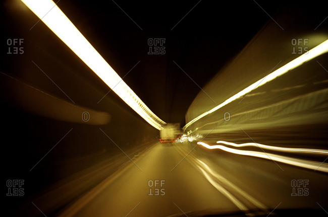 Cars driving through a tunnel, light leaking