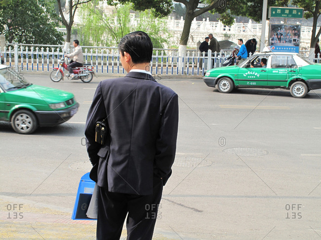 Man Waiting To Cross Street In Guiyang, China