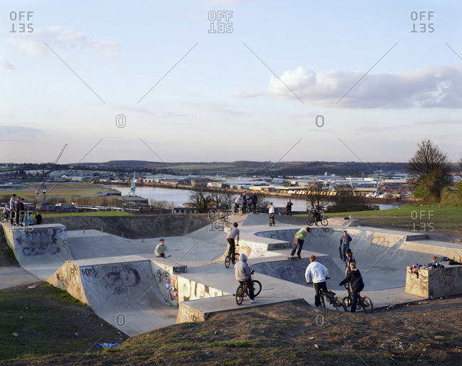 Teenage Bmx Riders And Skateboarders At A Skate Park During Sunset, Chatham, Kent, England, United Kingdom