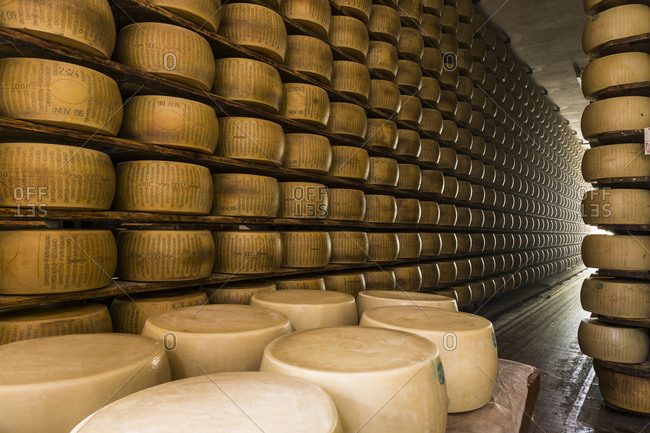 Traditional Parmigiano-Reggiano cheese wheels in a storehouse