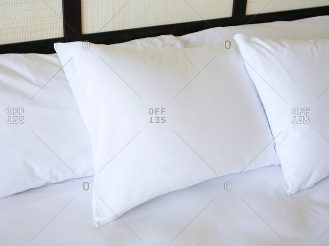 Fluffy white Pillows on bed