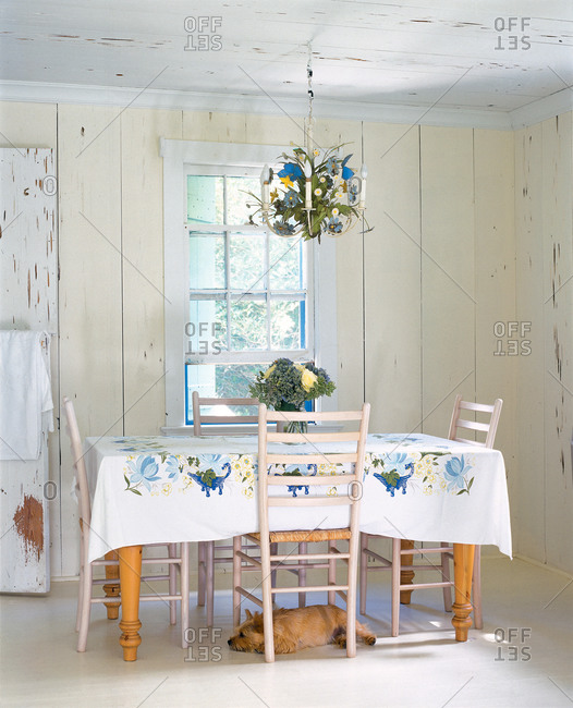 Country dining table with dog under under chair