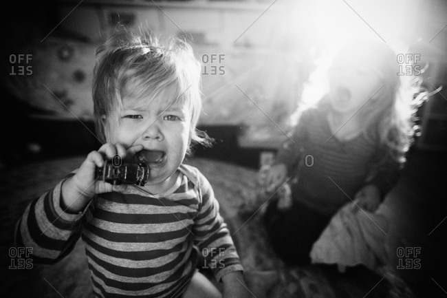 1 year old boy cries while holding toy car