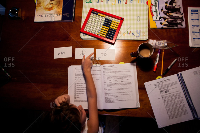 Overhead view of boy learning to read