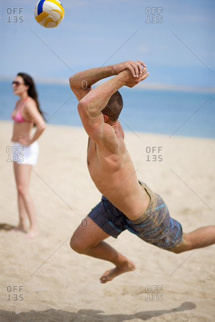 Friends playing volley ball at beach