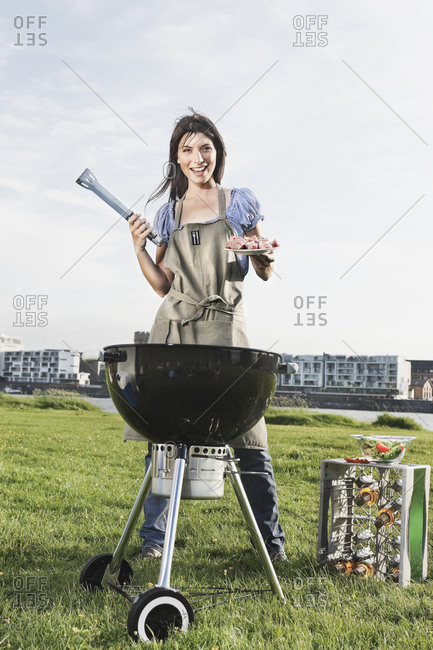 Young woman barbecueing, portrait