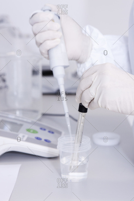 Germany, Bavaria, Munich, Scientist measuring pH value in laboratory