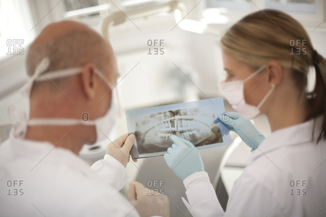 Germany, Bavaria, Landsberg, Dentist and Female Dentist Assistant holding an X-ray