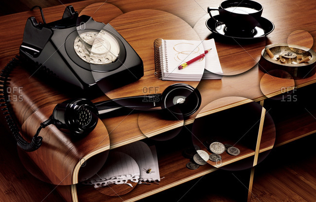 Telephone, notepad and ash tray on a desk