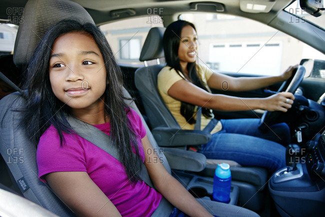 Mother and daughter driving in car