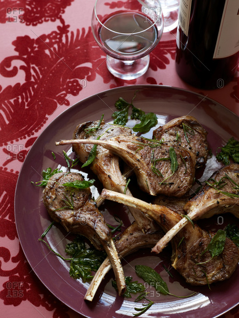Marinated lamb chops served with bottle of red wine