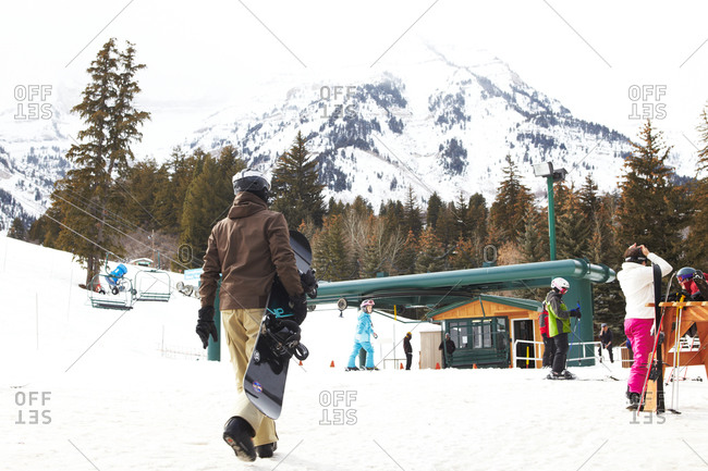 Young people walking around ski lift station on ski resort