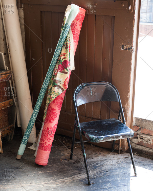 Interior composition with fabric bolts and old chair