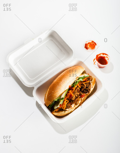 Beef sandwich with vegetables served in foam box for taking away