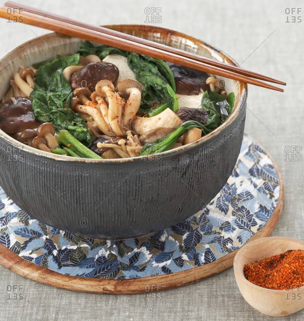 Japanese mushroom soup with spoon and chopsticks on table