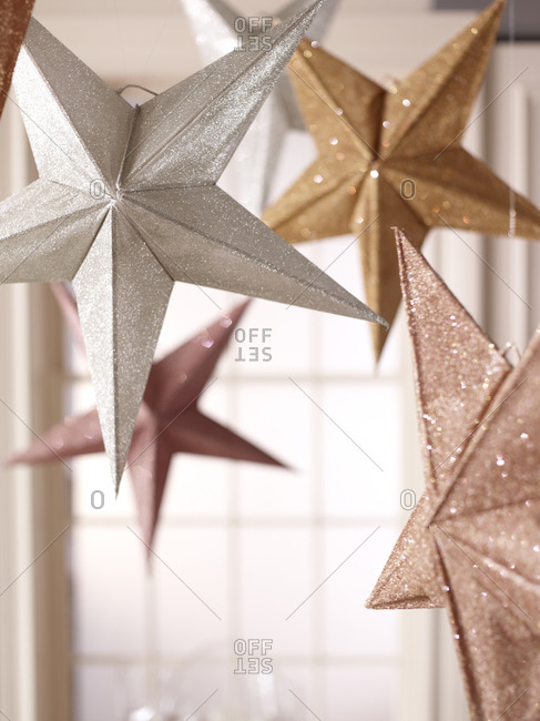 Close-up of glittering stars hanging from the ceiling