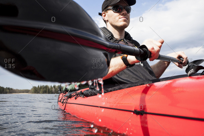 Low angle view of  man rowing kayak in lake